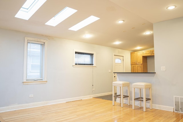 unfurnished room with vaulted ceiling and light hardwood / wood-style flooring