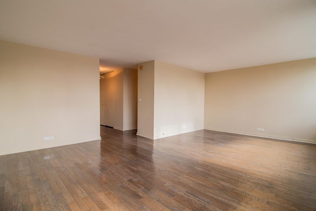 empty room featuring dark hardwood / wood-style flooring