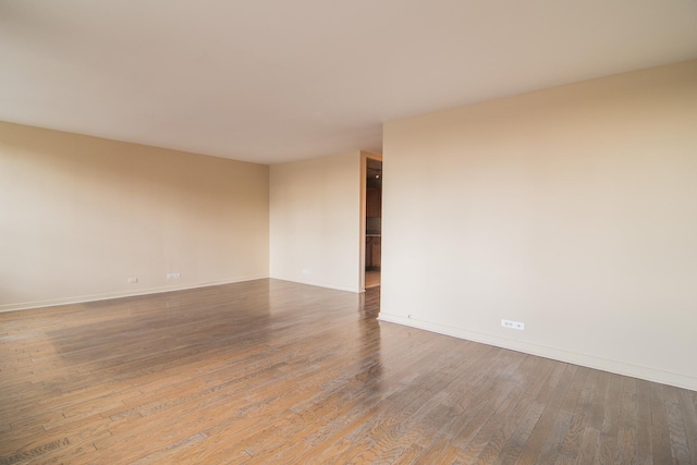 unfurnished room with hardwood / wood-style flooring