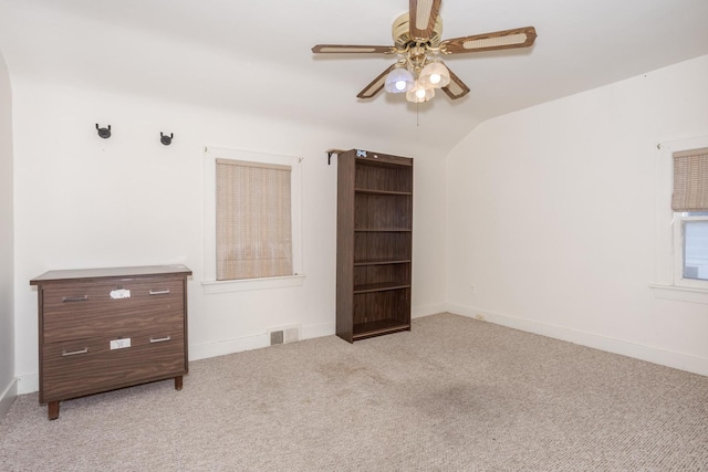 carpeted spare room with ceiling fan and lofted ceiling