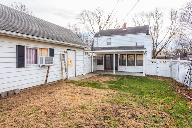 back of property featuring a yard, cooling unit, and a sunroom