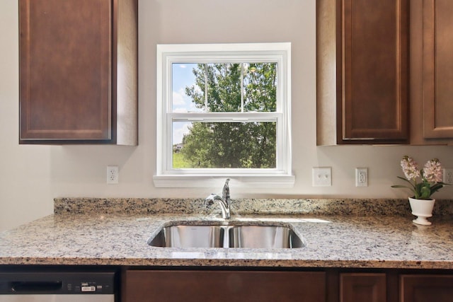 329 N Aspen Dr, Cortland, IL 60112 - kitchen with dishwasher, healthy amount of natural light, light stone countertops, and dark brown cabinets