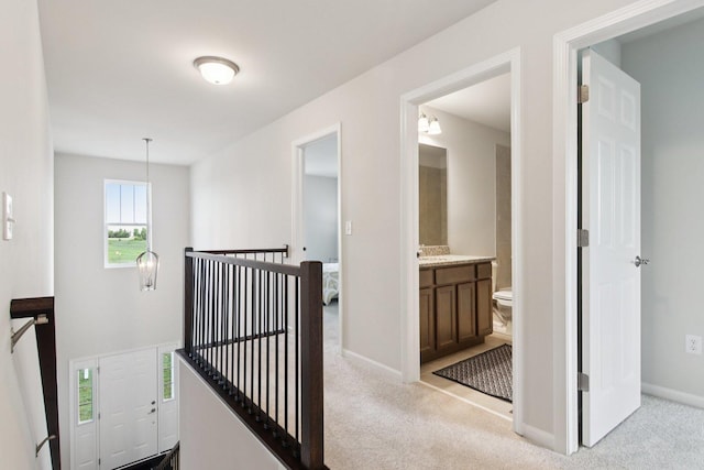 329 N Aspen Dr, Cortland, IL 60112 - hallway featuring an upstairs landing, carpet, and a chandelier