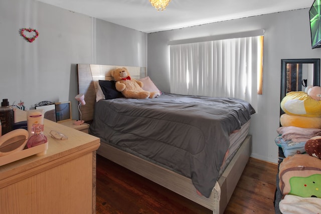 bedroom with dark hardwood / wood-style floors