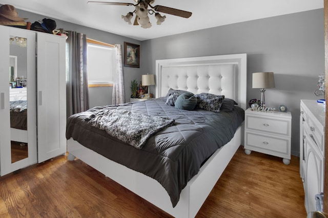 bedroom with ceiling fan and dark wood-type flooring