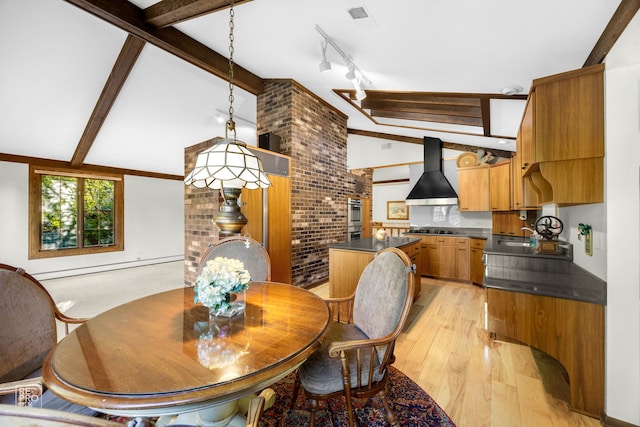 dining space featuring light wood-type flooring, vaulted ceiling with beams, a baseboard heating unit, and brick wall