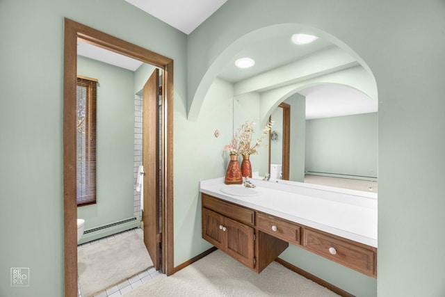 bathroom featuring tile patterned flooring, vanity, toilet, and a baseboard heating unit