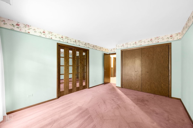 unfurnished bedroom with light carpet and a closet