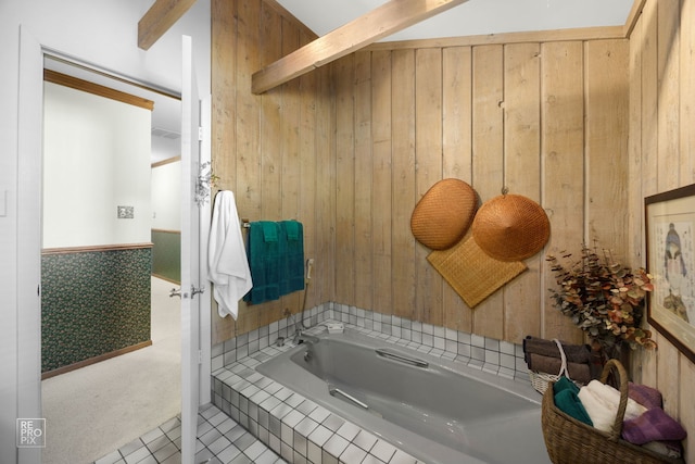 bathroom featuring wood walls and a bathtub