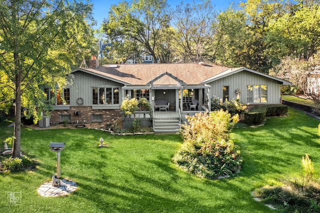 back of property featuring a yard and central AC unit