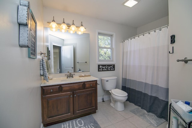 bathroom featuring tile patterned floors, vanity, toilet, and walk in shower