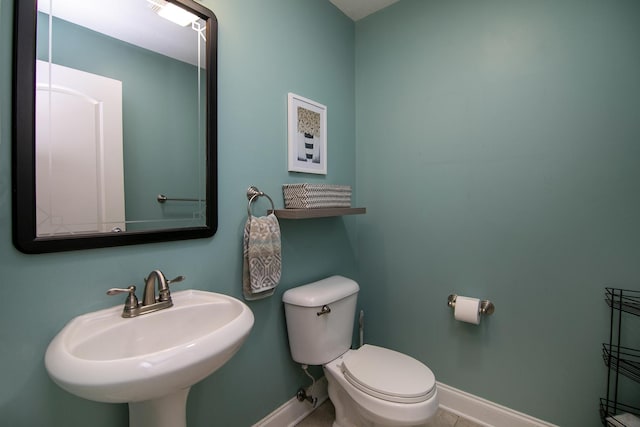 bathroom with tile patterned floors, toilet, and sink