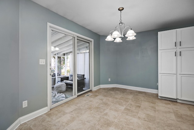 spare room with an inviting chandelier