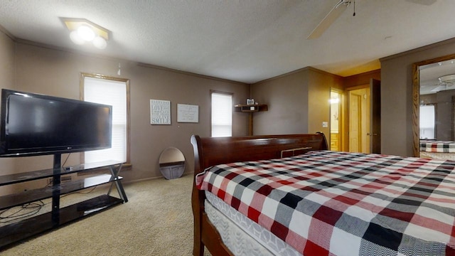 carpeted bedroom featuring a textured ceiling and ceiling fan