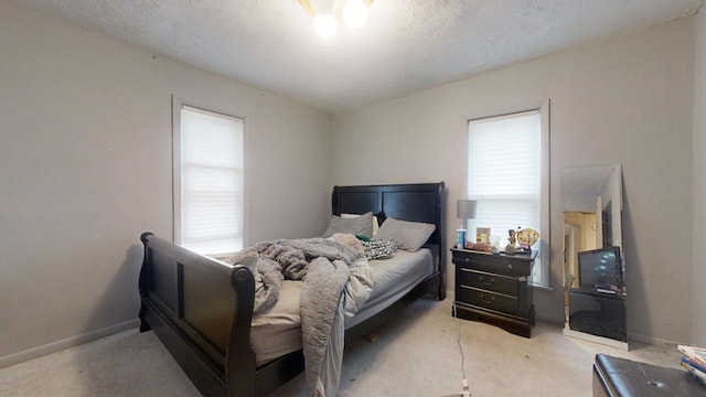 carpeted bedroom with a textured ceiling