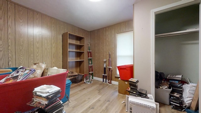 interior space featuring light hardwood / wood-style floors and wooden walls