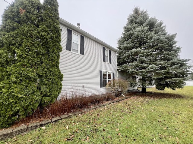 view of property exterior with a yard