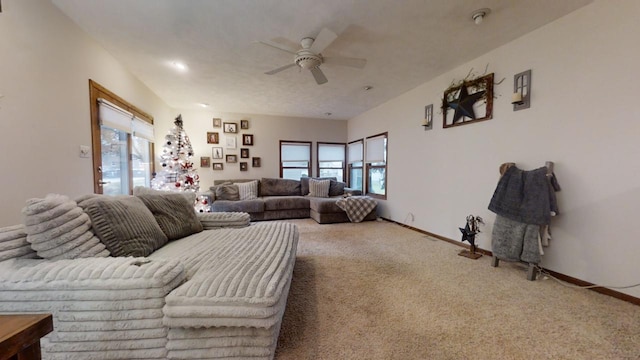 living room with carpet flooring, ceiling fan, and plenty of natural light