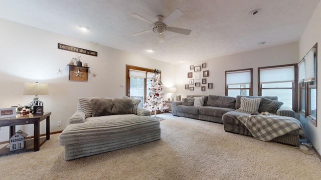 living room with carpet, ceiling fan, and a healthy amount of sunlight