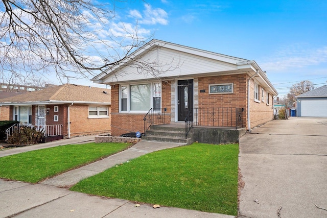 bungalow featuring an outbuilding, a front lawn, and a garage