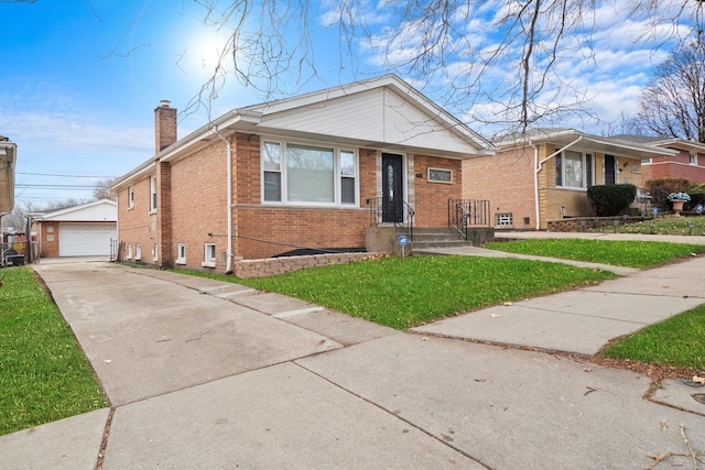 view of front of home with a garage, an outbuilding, and a front yard