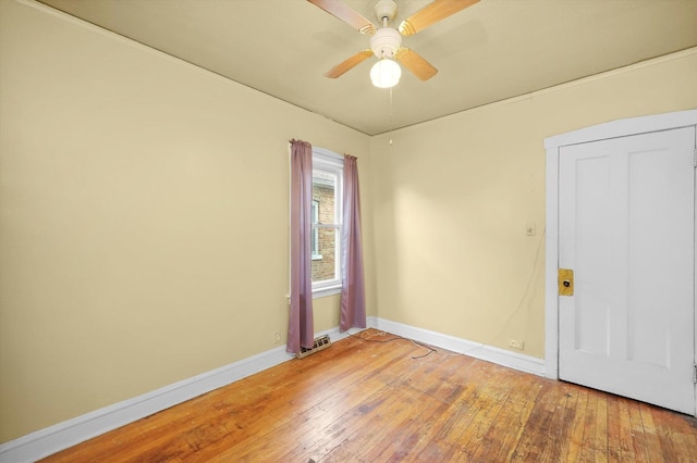 unfurnished room with ceiling fan and hardwood / wood-style flooring