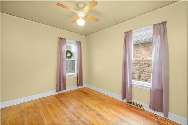 empty room with hardwood / wood-style flooring and ceiling fan