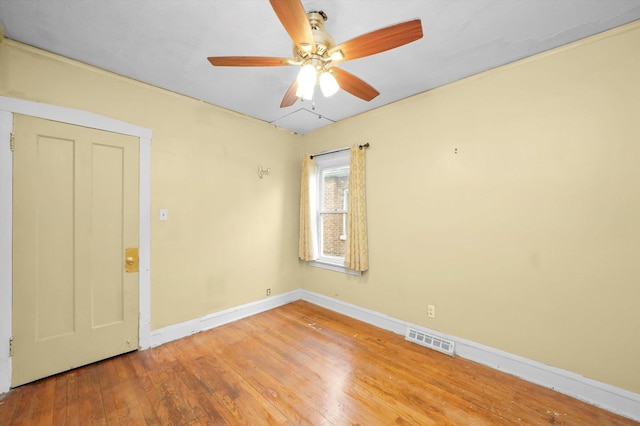 spare room featuring ceiling fan and hardwood / wood-style flooring