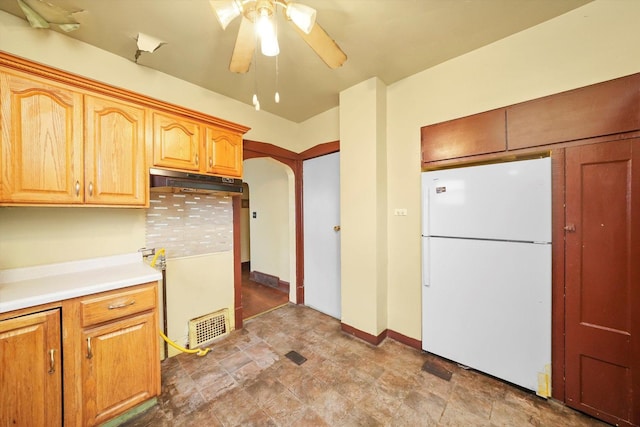 kitchen featuring ceiling fan and white refrigerator