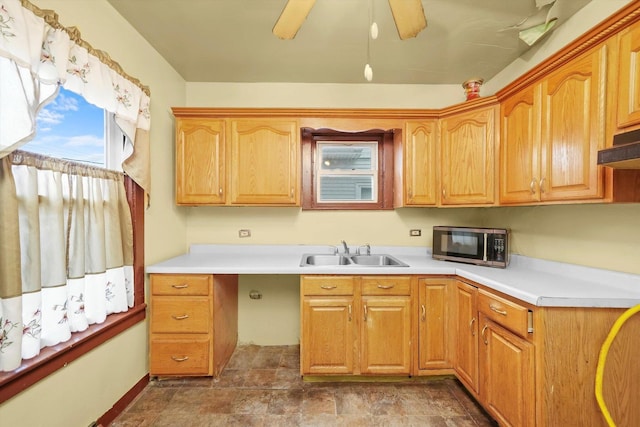 kitchen featuring ceiling fan and sink