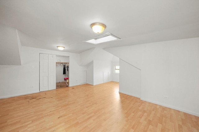 additional living space with light hardwood / wood-style flooring