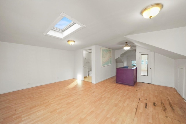 bonus room featuring vaulted ceiling with skylight, ceiling fan, and light hardwood / wood-style flooring