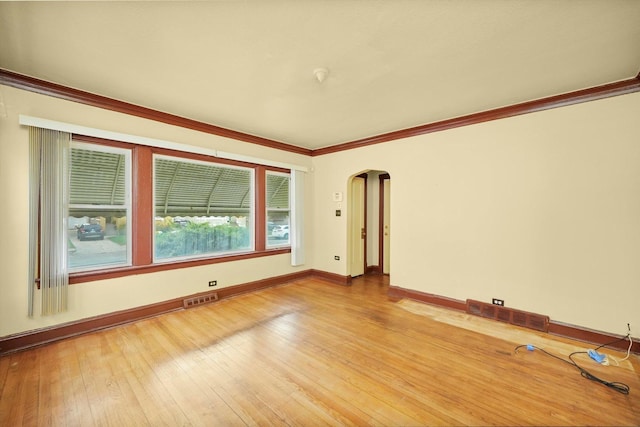 spare room featuring hardwood / wood-style floors and ornamental molding