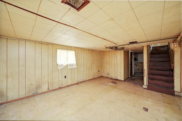 basement featuring wood walls