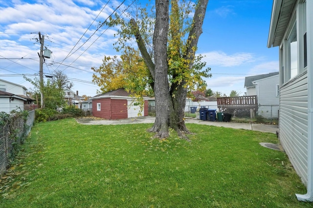 view of yard with a wooden deck and an outdoor structure