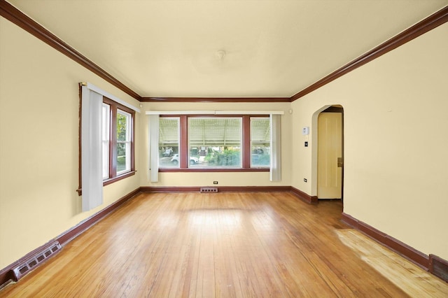 unfurnished room featuring light wood-type flooring and crown molding