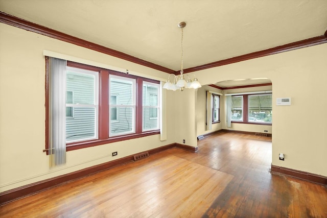 unfurnished dining area with hardwood / wood-style floors and ornamental molding