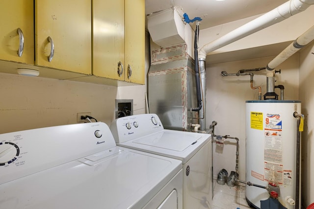 clothes washing area featuring cabinets, separate washer and dryer, and water heater