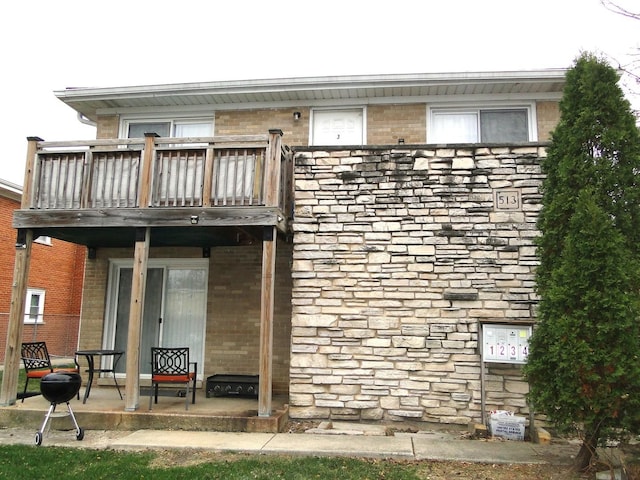 rear view of house featuring a balcony