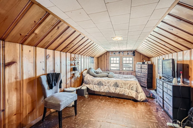 bedroom with wooden walls and lofted ceiling