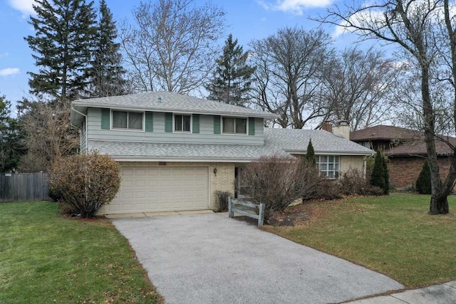 view of front of house with a front yard and a garage