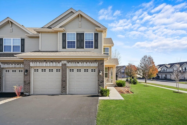 view of front of house featuring a garage and a front lawn