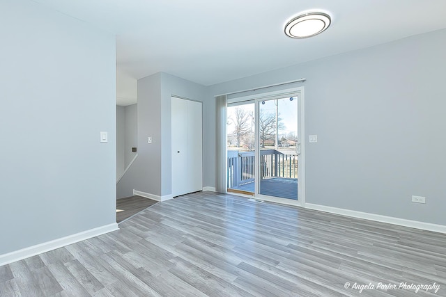 empty room with light hardwood / wood-style flooring