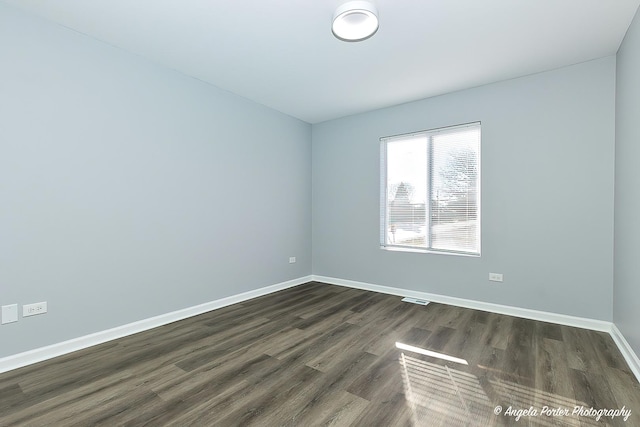 unfurnished room with dark hardwood / wood-style floors