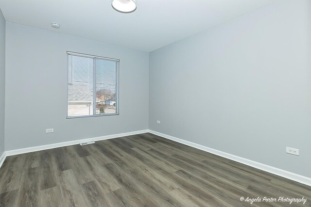 empty room with dark hardwood / wood-style floors