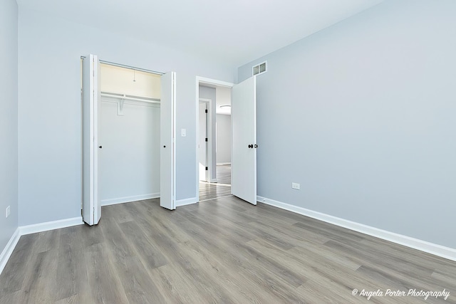 unfurnished bedroom with a closet and light hardwood / wood-style flooring