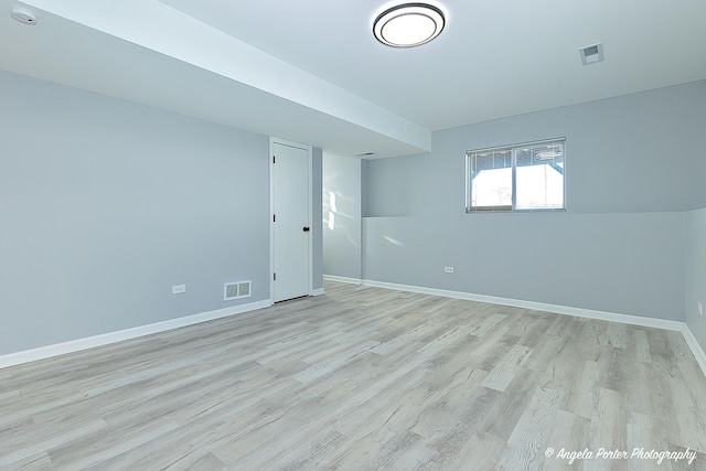 unfurnished room with light wood-type flooring