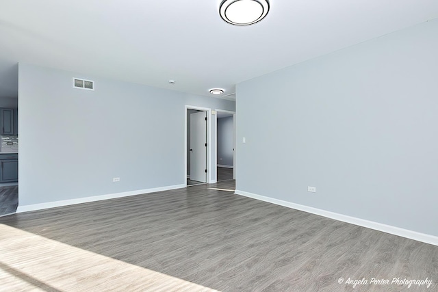 unfurnished room with hardwood / wood-style flooring