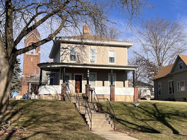 view of front facade featuring covered porch and a front lawn