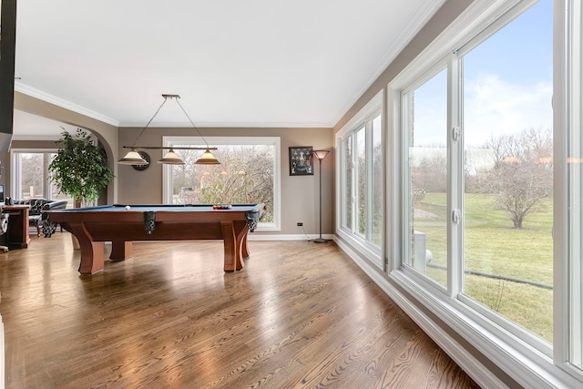 recreation room with a healthy amount of sunlight, wood-type flooring, crown molding, and pool table